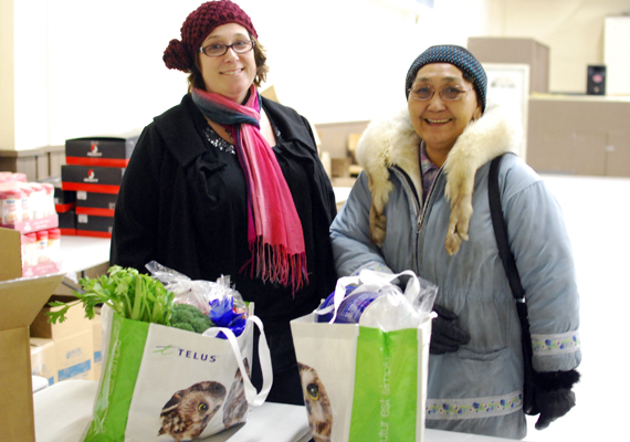 Tara Tootoo-Fotheringham, left, and customer Emilia Ramey at a recent fresh food fair held in Rankin Inlet. (PHOTO BY NOEL KALUDJAK)