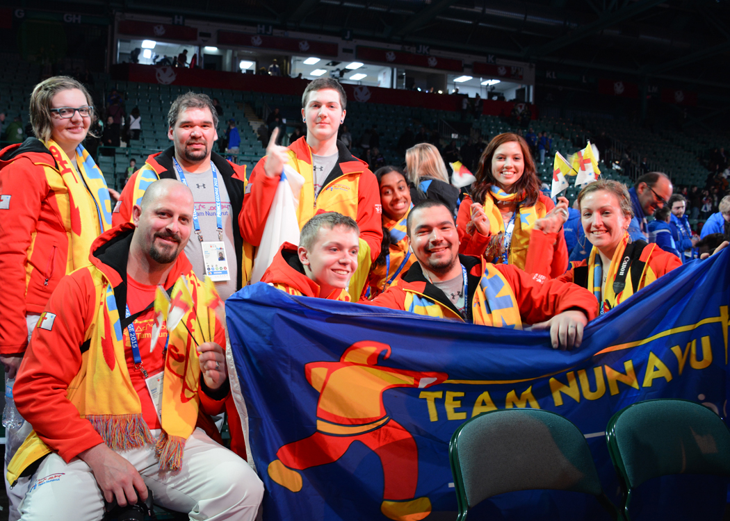 Some Team Nunavut coaches and athletes celebrate after carrying the Nunavut flag into the stadium at the opening ceremonies of the Canada Winter Games in Prince George, B.C., Feb. 13. Bottom row, from left: Brad Mainse (Mission Staff), Hayden Hickey (short track speed skater), Kyle St. Laurent (speed skating coach), Erica Stanley (speed skating manager).  Top row, from left: Mariele dePeuter (Chef de Mission), Jeff Seeteenak (Assistant Chef de Mission), Tyler Kirk (short track speed skater), Asini Wijesooriya (short track speed skater) and Halina Crowley (short track speed skater). The games run until March 1. (PHOTO BY JACQUELINE YOUNG)