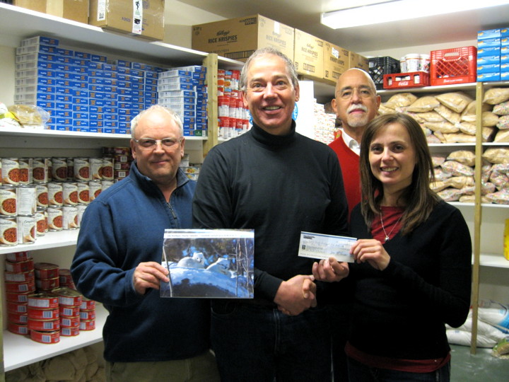 A trio of auditors from the Office of the Auditor General of Canada surround Stephen Wallick at Iqaluit’s Niqinik Nuatsivik Food Bank, March 11. Assistant Auditor General Ronnie Campbell, left, auditor Maria Pooley and, behind Wallick, Assistant Auditor General Jerome Berthelette, were in town this week to release a report on Nunavut Corrections. While in Iqaluit, the group dropped off a donation to the food bank of $1,000, raised from sales of the 2015 edition of the OAG’s Northern Charity Calendar. The calendar features photos taken by staff members during their tours of duty in Nunavut, the Northwest Territories and Yukon. (PHOTO BY PETER VARGA)