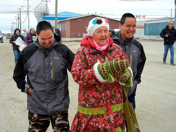 Eva Kakolak Avadluk, honoured with this year's Wise Woman award, walks with her two sons, Anthony and Ashlee Otokiak, who are blind, in the 2014 Embrace Life march around Cambridge Bay. (FILE PHOTO) 
