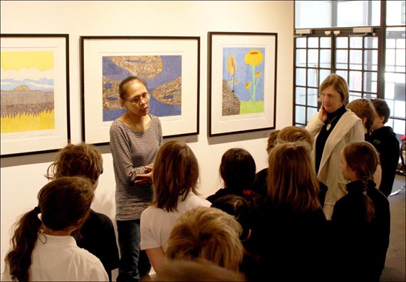 Nicotye Samayualie talks to a group of young students visiting her solo exhibition at Feheley Fine Arts last month. (PHOTO COURTESY OF FEHELEY FINE ARTS) 