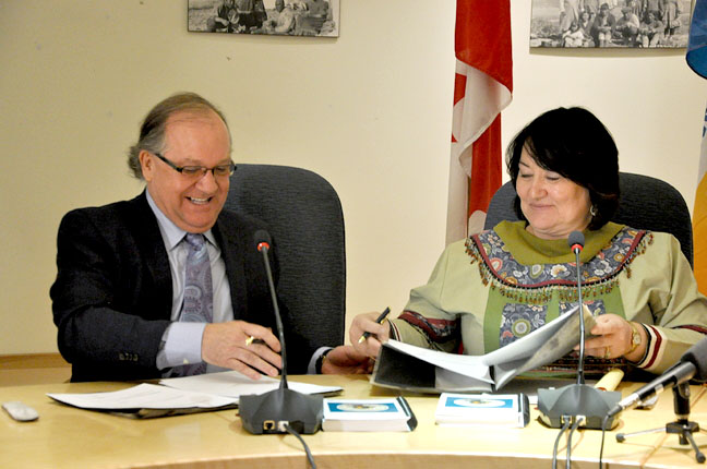 Out of court and now in hand: Nunavut's land claim body and the federal Crown signed a deal today that binds Ottawa to promises made in the 1993 Nunavut Land Claims Agreement, in a deal prompted by a lawsuit launched by Nunavut Tunngavik Inc. in 2006. The agreement, worth more than $255 million in compensation, includes $175 million to train Inuit for government jobs in Nunavut, in line with promises made under Article 23 of the land claims agreement. Aboriginal Affairs and Northern Development Minister Bernard Valcourt, left, visited Iqaluit to sign the papers with NTI president Cathy Towtongie. Read more details of the agreement on Nunatsiaqonline.ca. (PHOTO BY THOMAS ROHNER)
