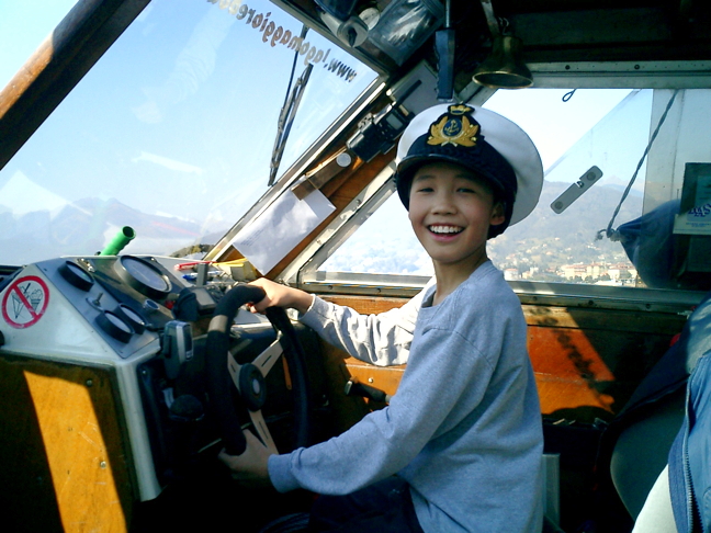 Captain Eric at the helm on Lago Maggiore in Northern Italy, 2005. He was 10 years old. (PHOTO COURTESY DAVID PELLY)