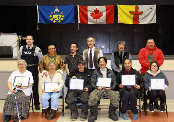 As one of her last events as Commissioner of Nunavut, Edna Elias awarded six bravery, volunteer and community service medals to residents of Igloolik May 6. Back row, from left: Const. Jean-Pierre Cormier; Hon. Edna Elias, Peter Ivalu, Mayor of Igloolik, Hon. Paul Quassa, MLA for Aggu, Hon. George Qulaut, MLA for Amittuq and Sgt. George Qattalik. The award recipients are pictured front row, from left: Marie Airut and Leonie Qrunnut (for providing counselling services and family support), Jonah Uyarasuk and Adam Qanatsiaq (for helping RCMP during a community incident), Simon Amaaq (for saving a fellow hunter’s life) and Aime Panimera (for volunteering.) (PHOTO COURTESY OF THE OFFICE OF THE COMMISSIONER OF NUNAVUT) 