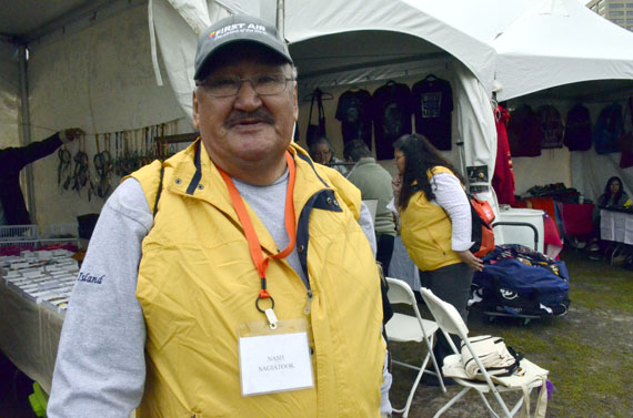 Nash Sagiatook of Iqaluit in front of Ottawa City Hall May 31, just before more than 3,000 residential school survivors and non-Aboriginal supporters completed their noon-hour Walk for Reconciliation between Gatineau and Ottawa via Portage Bridge and Victoria Island. Sagiatook helped staff a health tent where counsellors were available to help anyone in emotional distress. Justice Murray Sinclair, head of the Truth and Reconciliation Commission, said the TRC will release a 300-page executive summary of their final report June 2, with the two-million word full version of the report to come later after it's translated into various Aboriginal languages. On June 3, the TRC's public work will come to a close, following a round dance and concert featuring Buffy Saint-Marie. To see more photos, go to our Facebook page for an album of images. Stay tuned to nunatsiaqonline.ca for coverage of events this week. (PHOTO BY JIM BELL)
