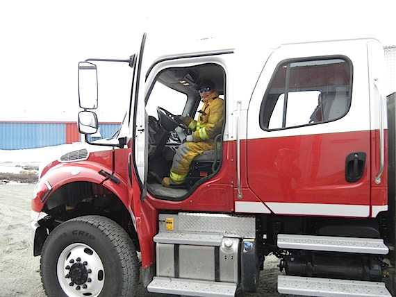 A Puvirnituq firefighter sits in the community's new fire truck in 2012. The community lost two residents to a deadly fire June 17. (FILE PHOTO) 