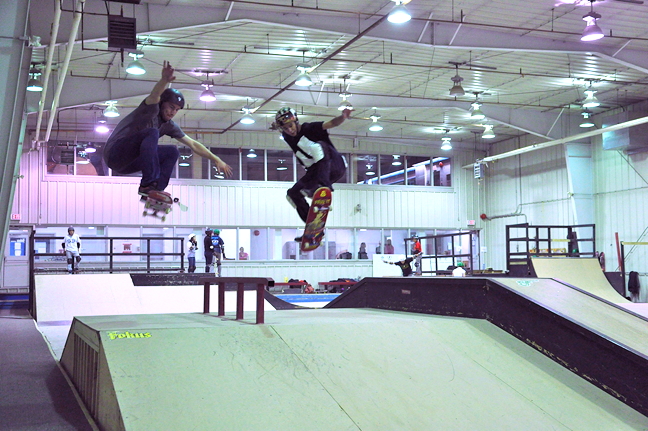 Isaac Daniel Idlout, right, and camp counselor Nick Gauthier soar through the air at the skateboard rink in Iqaluit Aug. 26. The annual summer skateboard camp, a perennial favourite among Iqaluit youth, runs from Aug. 23 to Aug. 30 this year. (PHOTO BY THOMAS ROHNER)