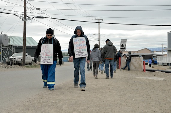 QEC workers walk in the picket line near the QEC headquarters in Iqaluit Aug. 10. (PHOTO BY THOMAS ROHNER)
