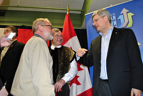 Prime Minister Stephen Harper greets supporters in Iqaluit during a visit on Feb. 23, 2012 as the Conservative senator for Nunavut, Dennis Patterson, looks on. Harper is due to fly into Iqaluit from Hay River late in the afternoon of Aug. 14 for a campaign event in the evening, where he'll help Conservative candidate Leona Aglukkaq launch her campaign for re-election. (FILE PHOTO)  