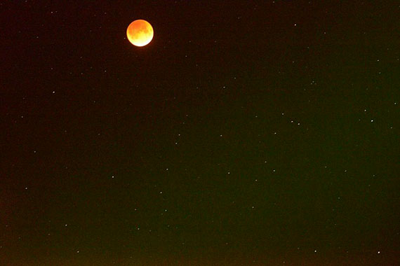 Noel Kaludjak was one of many skygazers and photographers who enjoyed the lunar show late Sept. 27. That included a total lunar eclipse, which gave way to this blood moon — called that for its reddish hue — which Kaludjak snapped over Rankin Inlet. The red tint comes from filtered sunlight passing through the Earth's atmosphere. (PHOTO BY NOEL KALUDJAK)