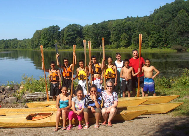Youth from Puvirnituq donned bathing suits and honed their skills in traditional Greenland kayaking recently under the guidance of kayak master Maligiaq Padilla in Grenville-sur-la-Rouge, Que., a training camp made possible with support from Makivik, Air Inuit, the Kativik School Board and student fundraising efforts. Front row, from left: Akinisie Sivuarapik, Rebecca Uqaituq, Rhoda Angma and Judy Renaud. Back row, from left: Tommy Nappartuq, Qumak Tukalak, Aipilie Qumaluk, Attamie Qumaluk, Jackussi Amamatuak, Maligiaq Padilla, Tamusi Novalinga, Alain Cloutier and Johnny Qumaluk. (PHOTO COURTESY ALAIN CLOUTIER)