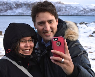 Liberal leader Justin Trudeau poses with an Iqaluit resident Oct. 10. (PHOTO BY STEVE DUCHARME)