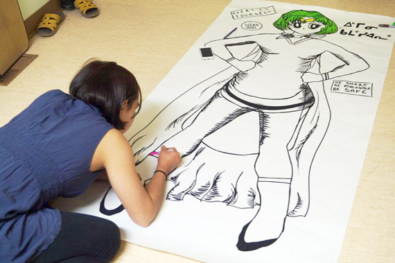 Charlotte Karetak works on a body mapping exercise in Arviat last summer, one in a series of workshops using arts and film to educate community youth about sexual health and healthy relationships. (PHOTO COURTESY OF JESSICA KWAN)