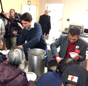 Liberal party leader Justin Trudeau helps serve food, with Liberal candidate Hunter Tootoo, at the Oct. 10 community feast in Iqaluit. (PHOTO BY STEVE DUCHARME)