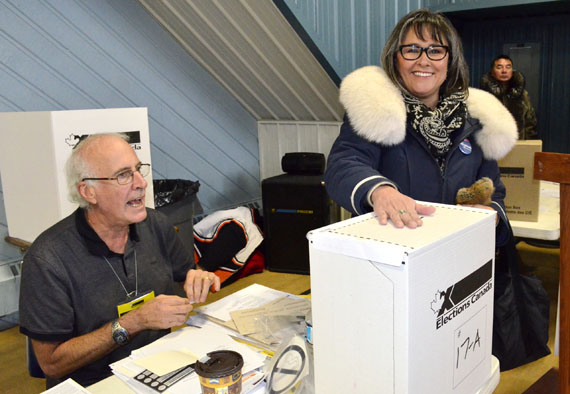 Leona Aglukkaq, the incumbent MP for Nunavut, casts her vote just after 11 a.m. Oct. 19 after standing in line at the Iqaluit Cadet Hall polling station. Polls opened in Canada's 42nd general election at 9:30 a.m. within the eastern time zone, and by about 10:15 a.m., a long line of voters were queuing up outside the polling station in Iqaluit. 
