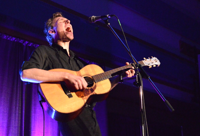 East-coast performer Joel Plaskett belts one out to a captive audience at a performance at Joamie School in Iqaluit Oct. 3, the second of two sold-out shows he played in Nunavut's capital. Plaskett, who has fronted several pull-together bands over the years, came North solo for the Alianait concert series, offering a stripped-down selection of his ample rock and folk repertoire to about 200 fans. The gregarious Maritimer told numerous candid stories between songs and at one point, said his trip to Iqaluit was as humbling as the first time his saw the