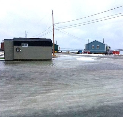 Rain water covers an icy street in Inukjuak Nov. 19. (PHOTO BY GEORGE BERTHE)