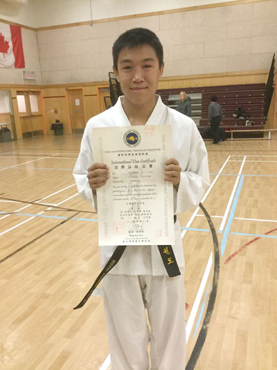 Simon Winsor with a certificate declaring he's passed all the requirements for a black belt in taekwondo. (PHOTO COURTESY OF ROBERT DYKSTRA)