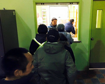Puvirnitumiut line up Oct. 15, the night the local co-op launched its beer and wine sales. (PHOTO COURTESY OF MUNCY NOVALINGA)
