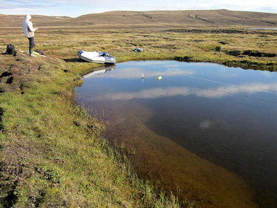 Researchers at a pond on Bylot Island measure the release of greenhouse gases. (HANDOUT PHOTO)