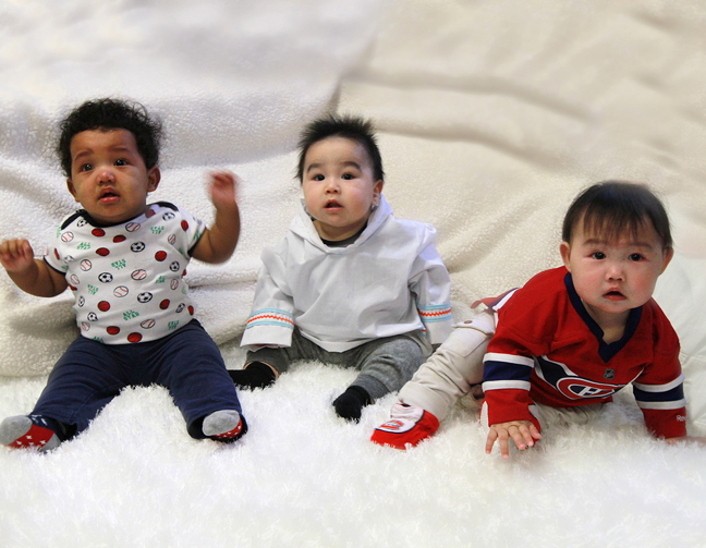 Simply irresistable — three of 25 babies born in Sanikiluaq in 2015: Grayson Appaqaq, Colton Meeko and Habs fan Rosanna Narlik. Nurse Manya Quinn, who works at the Sanikiluaq Health Centre, helped to make a calendar featuring those babies as a way to honour the dedicated, hard-working young moms and to raise money for local projects. Reporter Thomas Rohner chatted with Quinn, and some of the featured moms. You can read his story later on Nunatsiaqonline.ca. (PHOTO BY PETE BRENNAN)