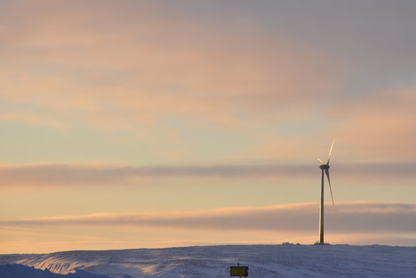 Raglan mine's 120-foot high, thee megawatt wind turbine turns outside the company's Nunavik mine site Dec. 1. One year after the turbine was first installed, Raglan says the mine site has saved 2.1 million litres of diesel and more than 6,000 tonnes of greenhouse gas emissions. This year, crews also installed an energy storage system at the site of the turbine to maximize wind power. (PHOTO BY SARAH ROGERS)