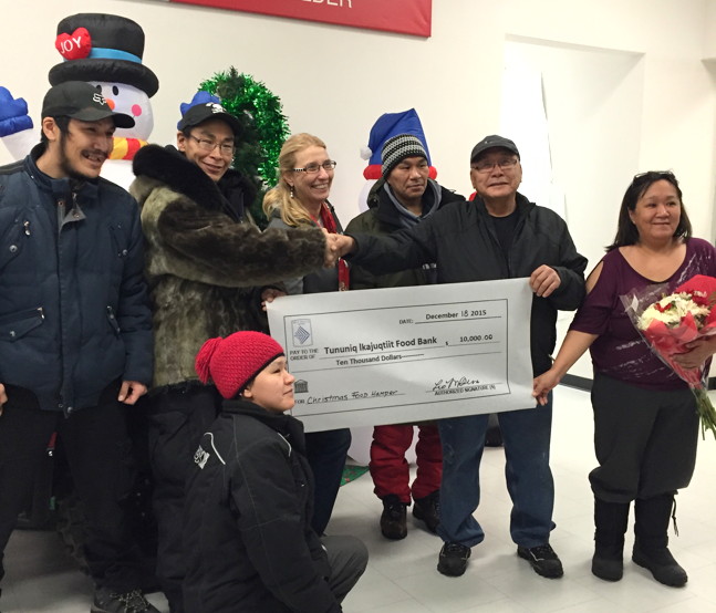 Leo Mucktar presents a cheque for $10,000 to the Pond Inlet Food Bank. From left: Ruben Arnakallak, Patrick Sangoya, Louise England, Bobby Aglak, Leo Mucktar, Rhoda Nutarak, and centre front, Susanne Kadloo. (SUBMITTED PHOTO)
