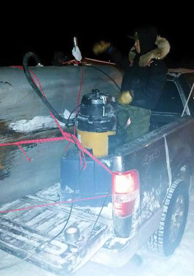 Residents of Coral Harbour have had to get creative with ways to collect sewage in recent weeks, like this attempt to use a Shop-Vac to suck sewage into a tank strapped into the back of a pick-up truck. (SUBMITTED PHOTO)