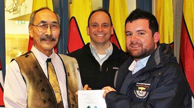 Nunavut’s education minister Paul Quassa, Nunavut Arctic College’s Sean Guistini and Nunavut linguist Conor Cook show off the new Utkuhiksalingmiut dictionary at the legislative assembly last October. Cook co-authored the book with anthropologist Jean Briggs and U of Toronto linguist Alana Johns. (PHOTO BY ERIC CORNEAU/NAC)
