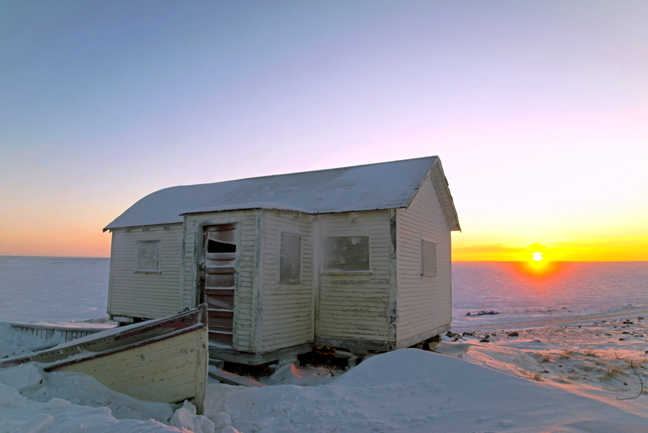 The first sun of 2016 in Cambridge Bay peeked over the horizon earlier this month, but cloudy skies and blowing snow prevented locals from enjoying its golden glow. The sun finally showed Jan. 15 at 12:15 p.m. Light from the sun's rays penetrated the space beneath the old Hudson's Bay Co. building above the shoreline and painted the snow there coral pink. (PHOTO BY DENISE LEBLEU IMAGES)