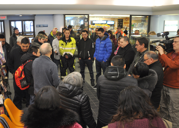 Rev. Mike Gardener leads F/V Saputi crew members in a seafarer’s prayer upon their return to the Iqaluit airport Feb. 26. (PHOTO BY SARAH ROGERS)