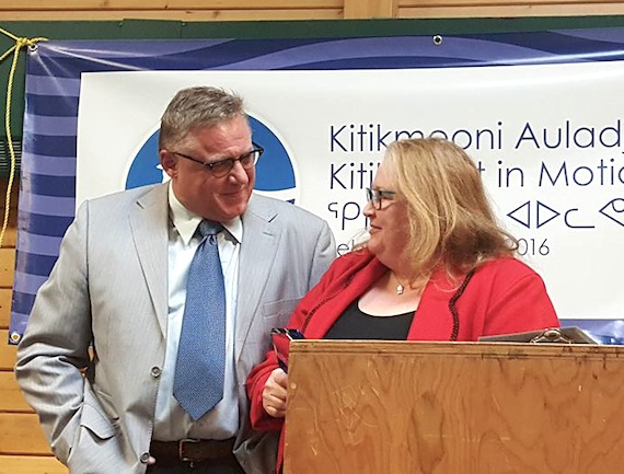 The Kitikmeot Trade Show in Cambridge Bay honours Vicki Aitaok Feb. 9, (right), as she accepts the Willy Laserich Corporate Award from Rene Laserich, (left) the son of the late bush pilot and Aviation Hall of Fame inductee Willy Laserich.  The annual award, handed out in honour of Willy Laserich, recognizes a member of the western Nunavut business community for his or her contributions. Aitaok, a full-time instructor at Nunavut Arctic College, also manages a concession at the airport and helps organize cruise ship visits to Cambridge Bay. (PHOTO BY JEANNIE EHALOAK)