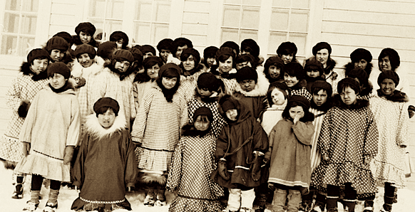 Inuit children from the western Arctic gather outside a residential school in this undated file photo. A dozen or so former students from the North have had their compensation claims denied for a variety of technicalities under the federal settlement agreement. (FLEMMING/NWT ARCHIVES: N-1979-050-0101)
