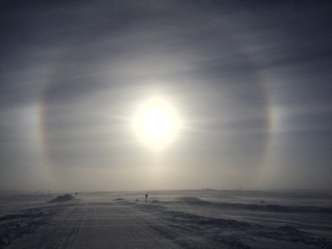 A spectacular sun dog hovers over a road near Rankin Inlet Feb. 14, offering a celestial target over a frozen land. Sun dogs, sometimes called 
