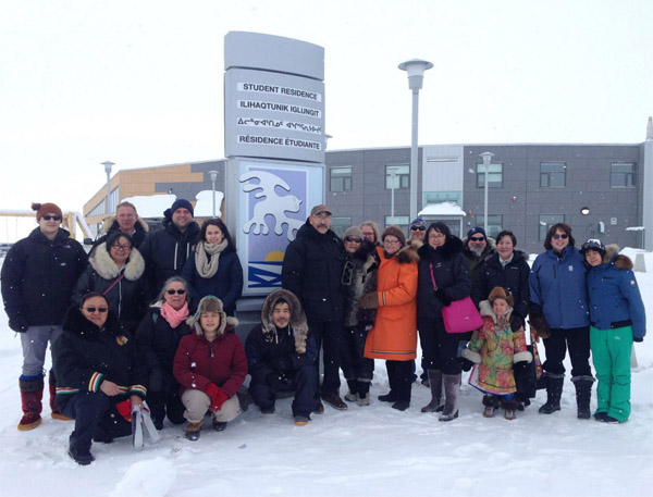 It's open! Students and staff join Nunavut Arctic College's board of governors, its chairperson, Elizabeth Ryan, and Paul Quassa, the minister responsible for Nunavut Arctic College, March 29 at the Kitikmeot college campus to officially open its new 20-student residence. (PHOTO COURTESY OF NAC)