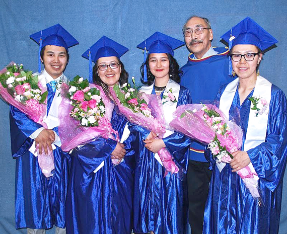 Secondary students from Netsilik school in Taloyoak celebrate their graduation May 18. From left, Peter Qayutinuak,Tammy Pauloosie, Wendy Alookee, Nunavut's Minister of Education, Paul Quassa, Phoebe Neeveacheak. The theme of Netsilik's graduation was perseverance, to recognize the efforts of the students — all of whom are young parents balancing their home lives and studies.