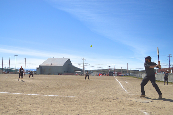 Warm weather and clear skies grace the first two days of Iqaluit's annual Canada Day-weekend softball tournament, with temperatures reaching into the double-digits. Clouds and cold winds moved in on the final day of the tournament July 3 and had many players retreating under blankets in the dugout when they weren't on the field. Team NASLs & Pitches went the distance after a long day of playoff rounds, beating out eight other teams to win the tournament and hoist the coveted Canada Day Cup trophy. (PHOTO BY STEVE DUCHARME)