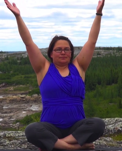Christine Watt demonstrates a yoga position in a Timiliritsianiq Nunavik Yoga video.