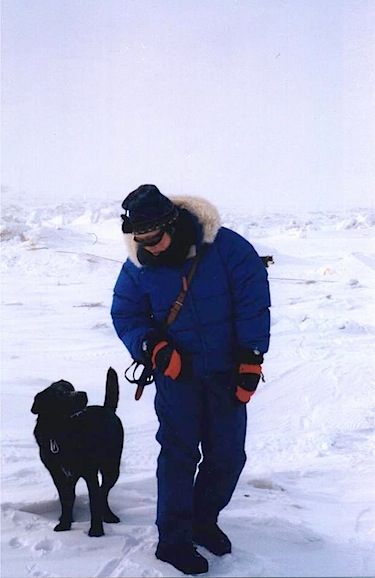 Siu-Ling Han on the ice outside Iqaluit in the late 1990s with her pet dog, Rupert, a Labrador mix. (PHOTO BY JANE GEORGE)