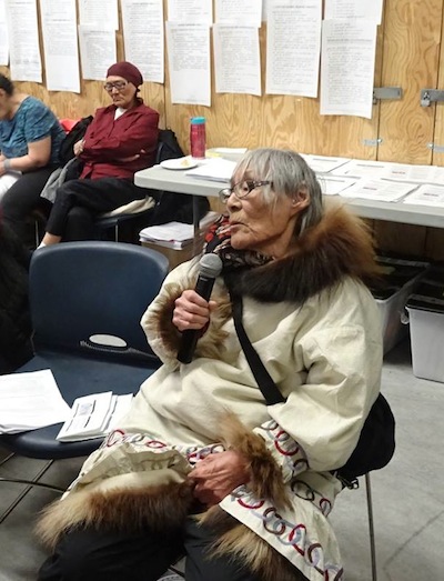 Elder Amy Kamoayok makes a comment April 27 at the NIRB's final hearing on the Back River gold mine project. Caribou are our history, said Kamoayok, who was born near Bathurst Inlet. Kamoayok, with her family, would walk and hunt inland in the area where Sabina wants to build a four-mine, underground and open-pit gold extraction complex. Speaking in Inuinnaqtun, Kamoayok also recalled the words of her late grandfather, who had a vision of a meeting where people would discuss the future of the area where they would see thousands of caribou from the now-dwindling Bathurst caribou herd pass by. (PHOTO BY JANE GEORGE)