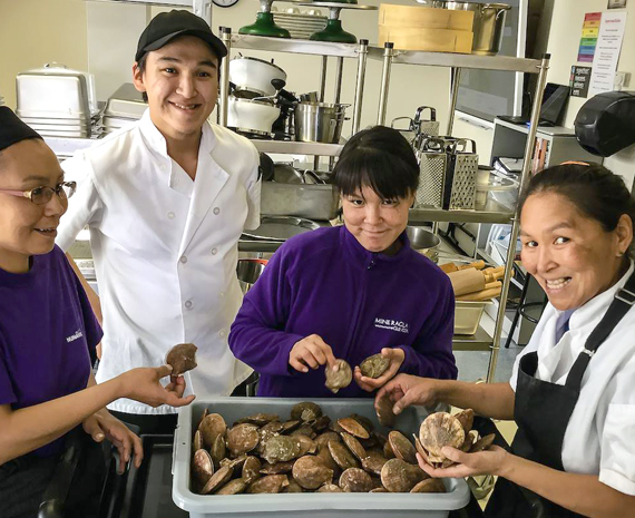 Students at the Nunavimmi Piguarsivik school in Inukjuak clean scallops as part of a cooking course at the Nunavik technical and vocational school, which just started up again earlier this month. (PHOTO COURTESY OF KSB) 
