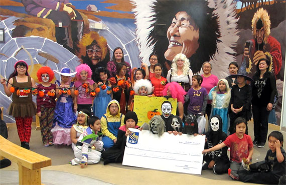 Staff and participants of the Kitikmeot Heritage Society’s after-school program pose last month in their Halloween costumes, holding a giant cheque for $20,000. The money is a recent donation from the Royal Bank of Canada towards the Cambridge Bay-based youth program—a vital contribution to its ongoing programming, the KHS said. (PHOTO COURTESY OF KHS)