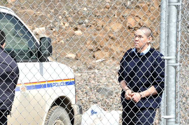 Police escort Peter Kingwatsiak to an RCMP truck during a break on day one of his first-degree murder trial in Iqaluit, June 22, 2015. (PHOTO BY THOMAS ROHNER)