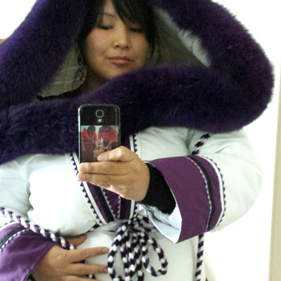 Pasha Abraham, a Creenuk living in Whapmagoostui, poses for a photo in her amautik. Abraham speaks Inuktitut and wants to participate more in her Inuit culture, but feels limited as a Cree beneficiary. (HANDOUT PHOTO)