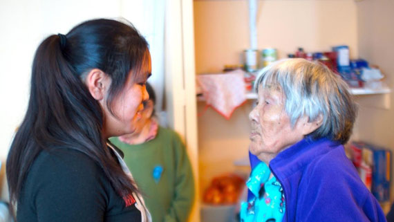 Puvirnituq elder Mary Sivuarapik and her granddaughter Akinisie Sivuarapik, throat sing Dec. 7 during a visit from Iguarsivik School's Qajaq project participants with elders at Sailivik, Puvirnituq's elders home. During the visit they shared food prepared by the students and watched a 1976 film of elders building qajait along with videos of youth building and paddling traditional qajait over the last 15 years. (PHOTOS BY ALAIN CLOUTIER)