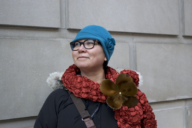 Oo Aqpik models a sealskin adorned scarf she made. Aqpik's works are part of the Studio Sixty Six gallery's 