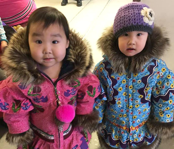 Cousins Erica Taipana of Cambridge Bay, 22 months old, and Ophelia Bolt of Kugluktuk, 20 months old, model their new winter parkas. The traditional Kitikmeot-style parkas were made by the girls' grandmother, seamstress Lucy Taipana of Kugluktuk.  (PHOTO COURTESY OF JAMIE TAIPANA)