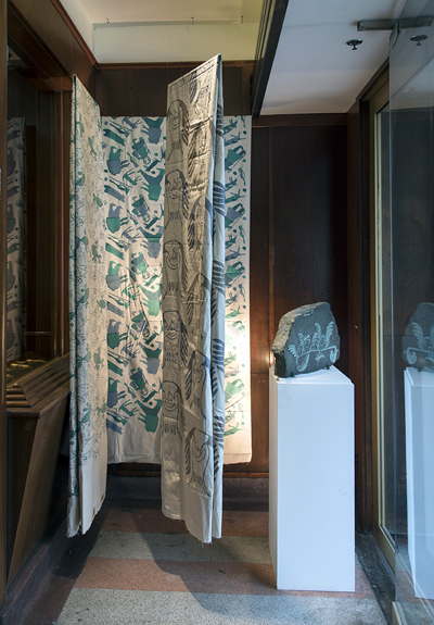 Textiles hang on display in the Drake's front entrance, along with a stoneblock called Spectator Birds, made by Lucy Qinnuayuak in 1970. (PHOTO BY CHERYL RONDEAU)