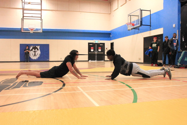 Master of Inuit games, Johnny Issaluk, left, and his reluctant challenger, Christian Thomas, 17, demonstrate the neck pull following the Bell Let's Talk mental wellness event at Inuksuk High School Jan. 18.