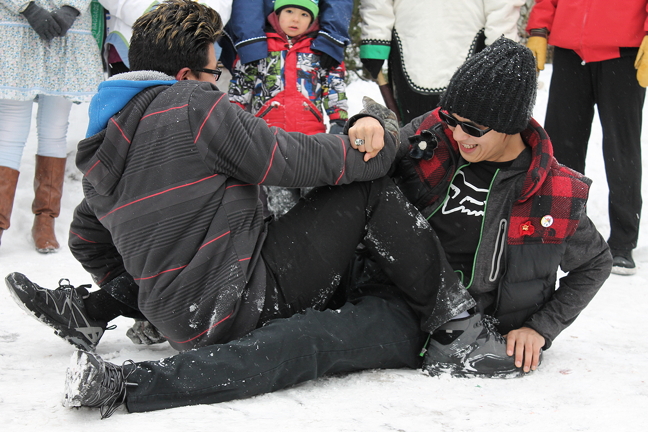 Michael Pewatualuk and Justin Milton challenge each other to the armpull during Inuit Day celebrations Feb. 11 in Ottawa. The afternoon event, organized by the Ottawa Inuit Children's Centre, included country foods, throat singing and traditional games. Nunavut Sivuniksavut students performed dances and traditional drum songs and also demonstrated some of the traditional games. (PHOTO BY KELLY BUELL)